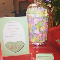 A picture of a jar filled with candy conversation hearts.