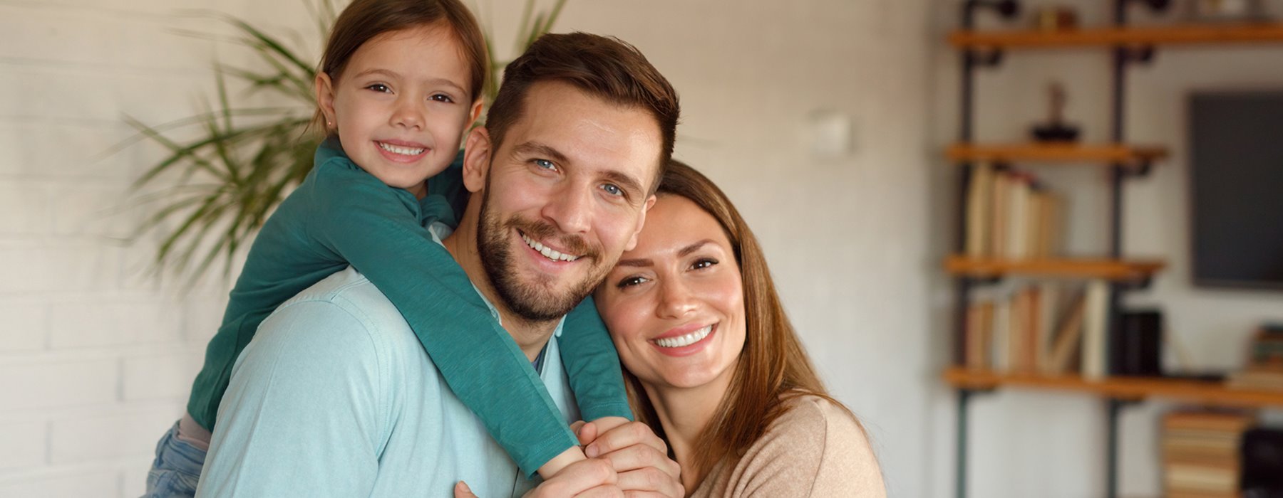 A happy family smiles together at Phelan Braces Orthodontics.